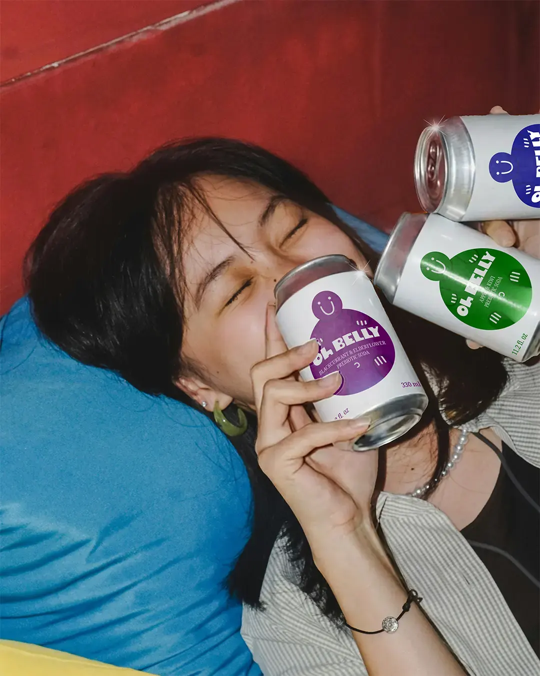 Oh Belly - Woman Posing with 3 Cans