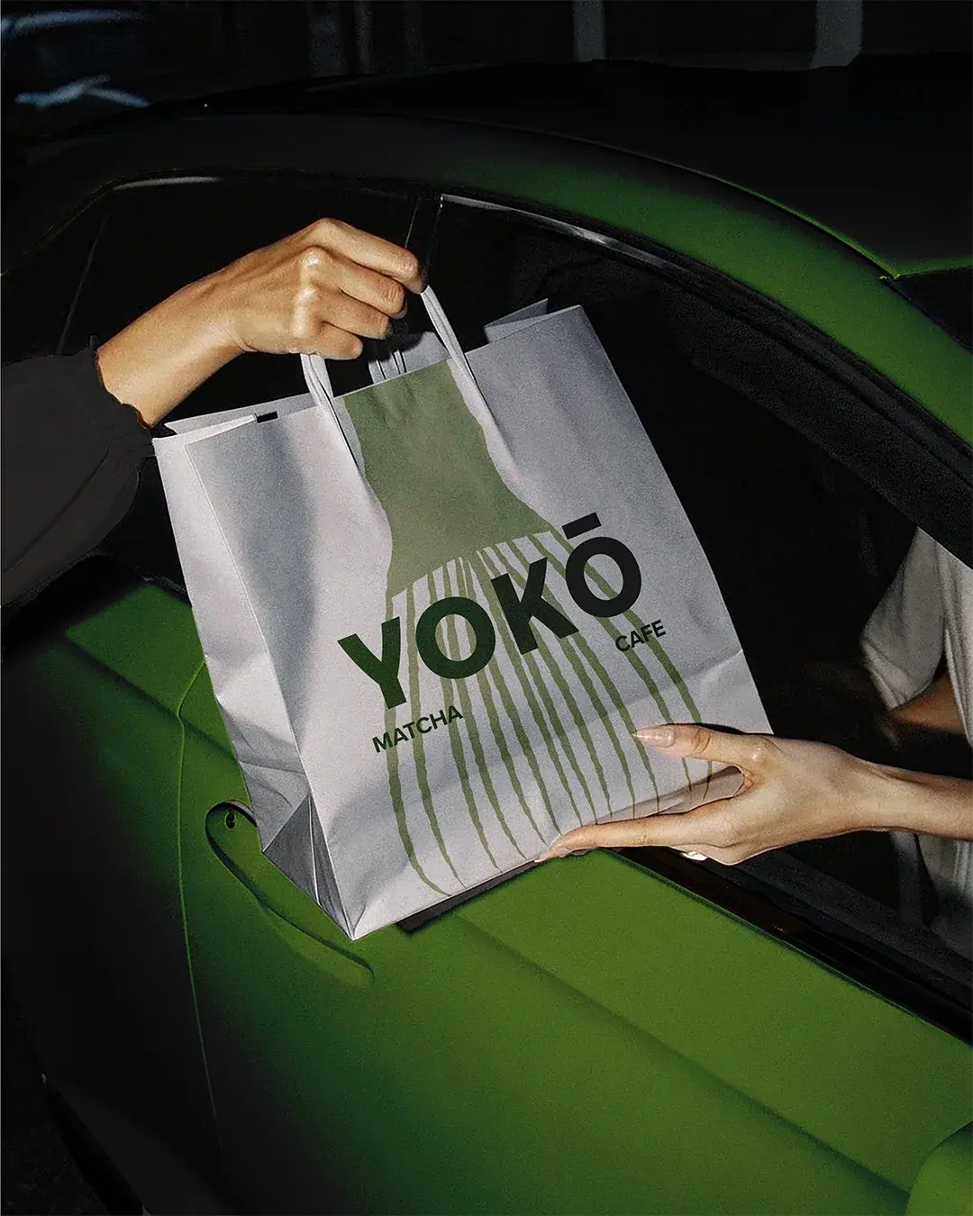 YOKŌ Bag Being Passed Into Car